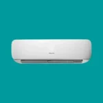 White wall mounted air conditioner indoor unit against teal background behind it