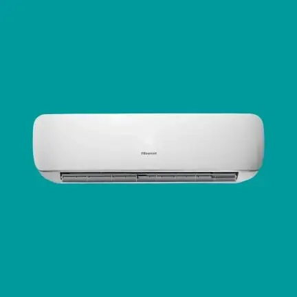 White wall-mounted air conditioner indoor unit against teal background behind it.