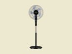 Black pedestal standing fan with a circular grille and translucent blades placed on a beige background