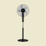 Black pedestal standing fan with a circular grille and translucent blades placed on a beige background
