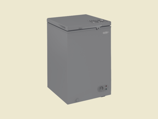 Gray compact chest freezer with a top opening lid and a control dial at the lower front right