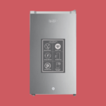 Tall stainless steel appliance KenStar with a feature panel displaying Whisper Quiet Power Chill Energy Efficient Deodorizing Anti Bacterial and Ultra Fresh Storage against a red background
