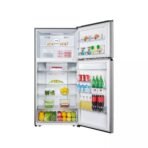Open stainless steel refrigerator showing shelves filled with dairy fruit vegetables and beverages on a bright white background nearby