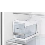 White water reservoirtank inside a refrigerator labeled MAX 42L mounted on the back wall next to a shelf