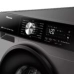 Close up of a Hisense washing machine control panel with a large circular dial and digital display showing the cycle time