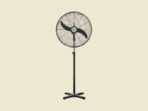 Black standing pedestal fan with a circular grille and four legged base on a pale yellow background