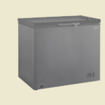 Grey chest freezer with top opening lid and front control knob set against a pale background