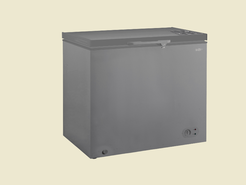 Grey chest freezer with top opening lid and front control knob set against a pale background