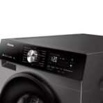 Close up of a front loading washing machine with a digital display showing 120 and a large metallic control knob