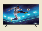 Television screen showing a soccer player mid air kicking a ball in a brightly lit stadium at night