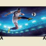 Television screen showing a soccer player mid air kicking a ball in a brightly lit stadium at night
