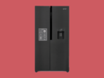 Black French door refrigerator with an external water dispenser on the right door standing against a red backdrop