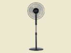 Black pedestal fan with circular grille on a pale beige background ready to cool a room