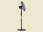 Black pedestal fan on a stand with a round base against a pale background viewed from the side