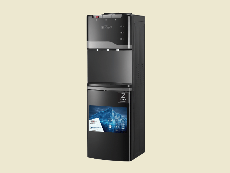 2025111011043223png | Mitos Shoppers Tall black water cooler dispenser with hotcold taps and a bottom compartment set against a pale background