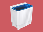 White top loading washing machine with a blue transparent lid on a red background