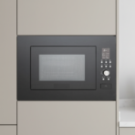 Integrated microwave oven in a beige kitchen cabinet with control panel on the right side and a glass window door for heating food