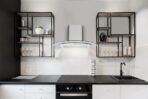 Modern kitchen with black metal open shelves white tiled backsplash stainless range hood and black countertop