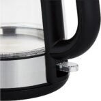 Close up of an electric kettle showing a black handle and a chrome control knob near the base