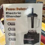 Power Deluxe Electric Blender box featuring a tall blender image and model PDB 8231 W in a store setting