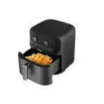 Black compact air fryer with a pulled out drawer filled with golden French fries Optimized for quick frying in home kitchens