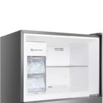 Open chest freezer showing built in ice maker and two ice cube drawers with ice inside