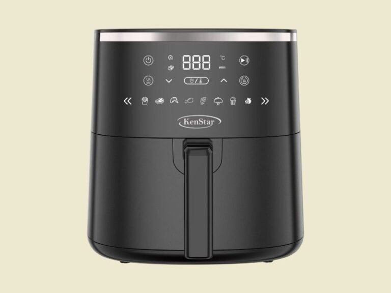 Black KenStar air fryer with digital control panel and vertical handle on a pale yellow background