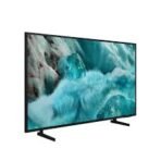 Slim flat screen monitor on a stand displaying a photo of turquoise waves crashing