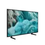 Slim flat screen monitor on a stand displaying a photo of turquoise waves crashing