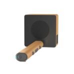 Wooden Bluetooth speaker with a separate handheld microphone like device in front black front panel orange wood grain sides and a teal LED on the device