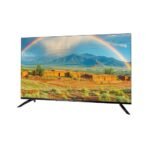 Flat screen television on a two legged stand displaying a desert landscape with a rainbow in a blue sky